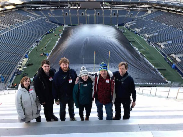 Group photo of the PNSN staff that installed the seismometers in 2017, posing in front of an empty Century Link field.